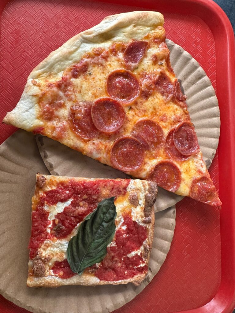 Slice of pepperoni pizza from made in new york pizza